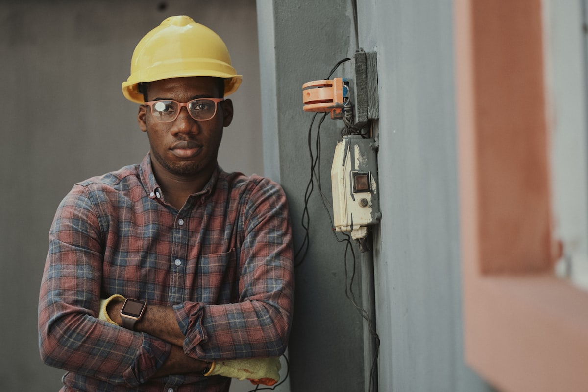An electrician testing circuits inside an open residential breaker panel.